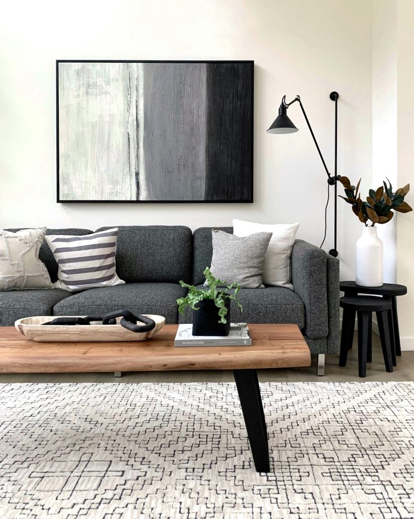 black and white throw pillows on gray couch