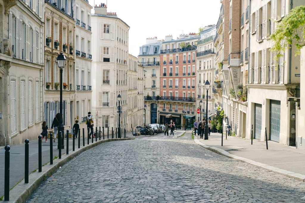 people walking on street between buildings during daytime