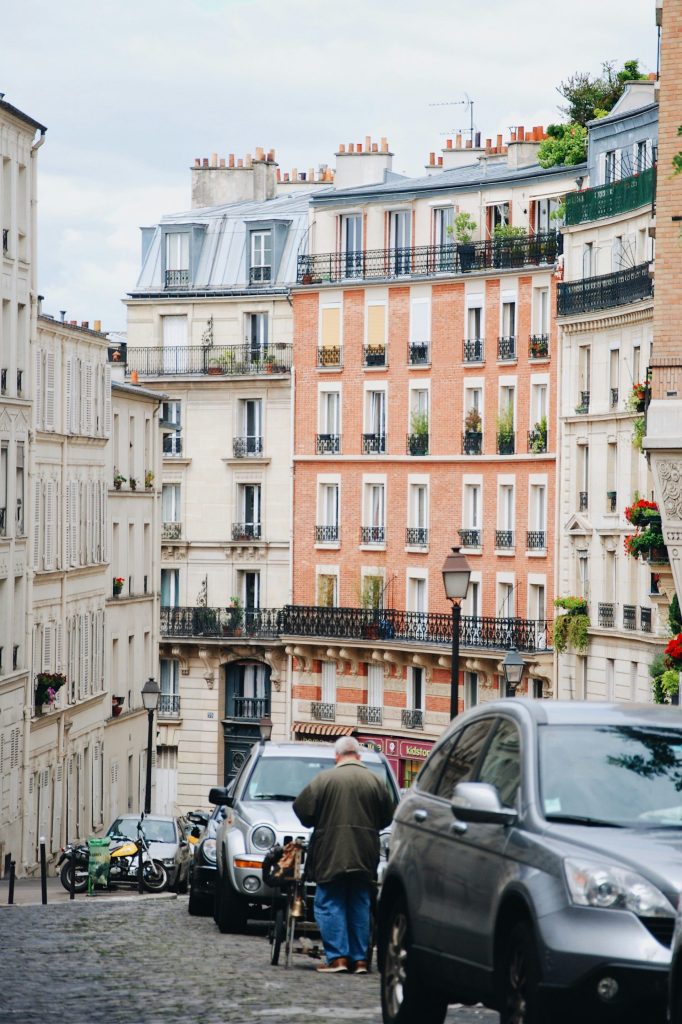 man walking beside gray vehicle